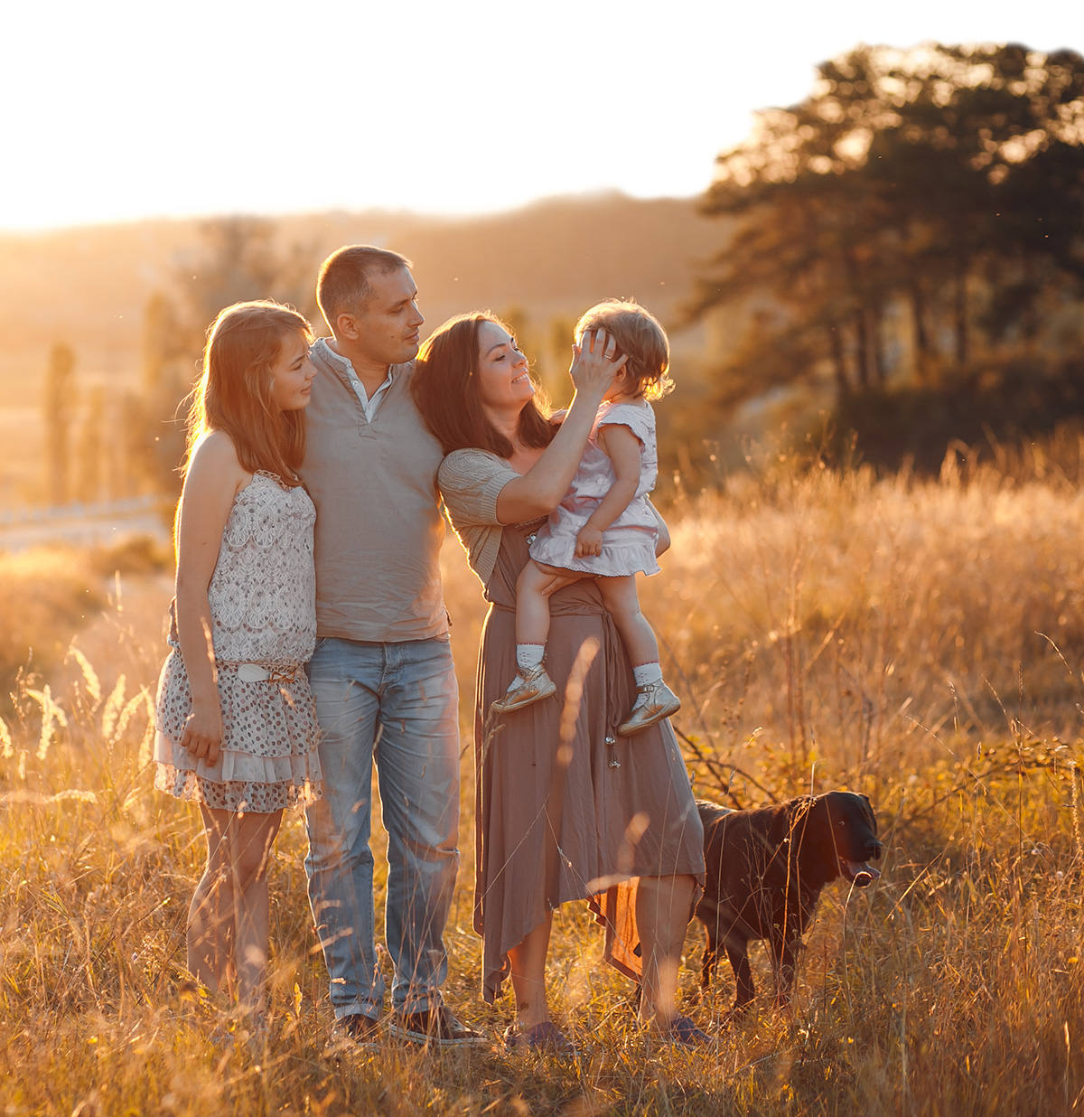 Picture showing a family together with a dog